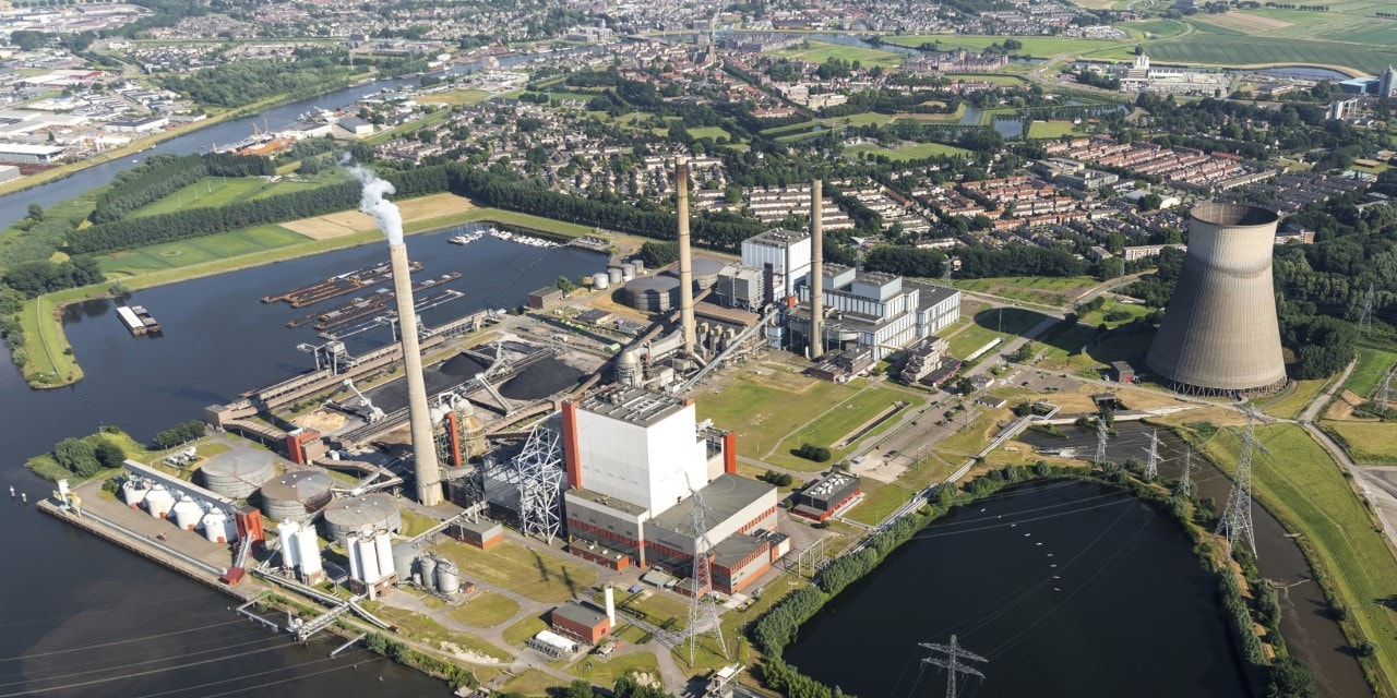 19 July 2016, Geertruidenberg, Holland. Aerial view of the AMERCENTRALE, a coal and biomass fired Essent powerplant. It's located at the river Amer. In the back the town of GEERTRUIDENBERG.