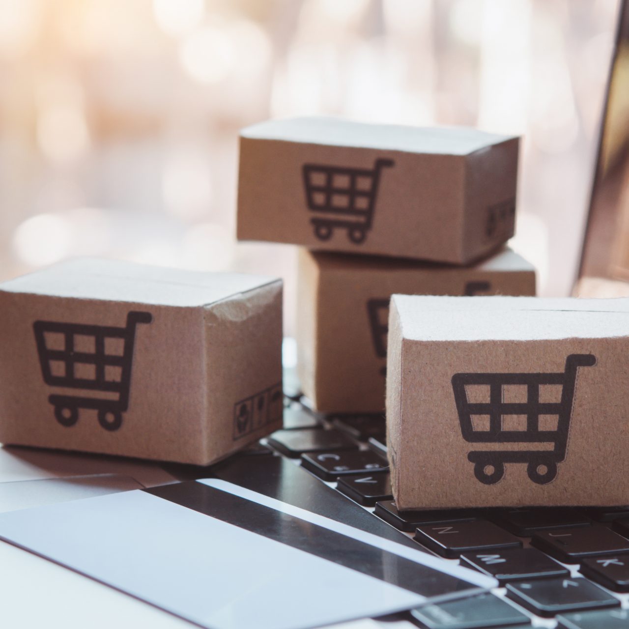 Shopping online. Credit card and cardboard box with a shopping cart logo on laptop keyboard. Shopping service on The online web. offers home delivery